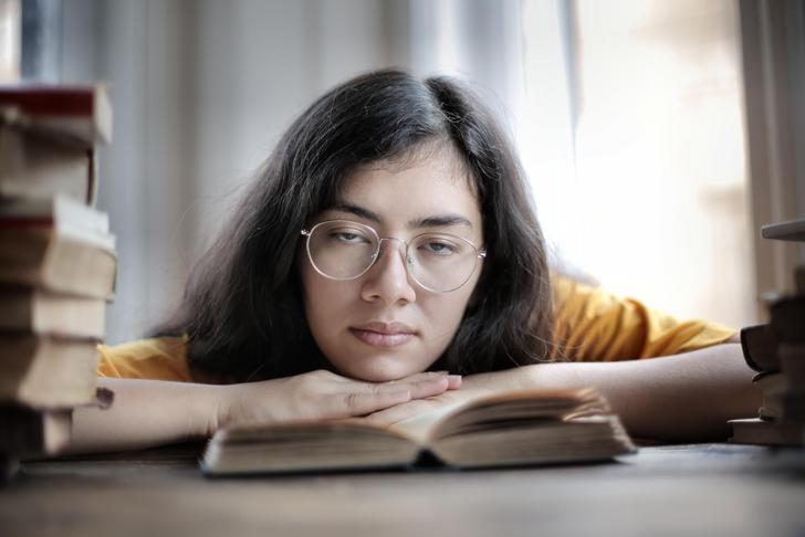 fatigued woman leaning on desk