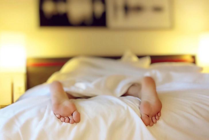 feet of person laying on a bed