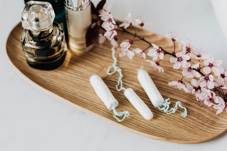 feminine products on wooden tray