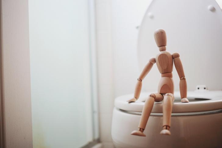 figurine sitting on a toilet