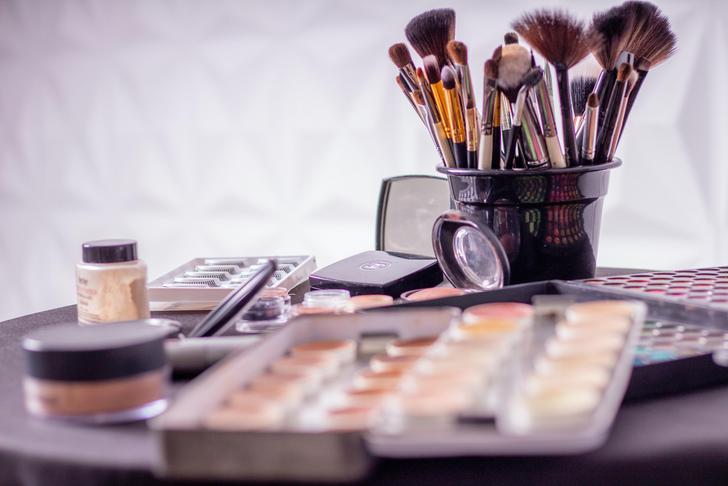 makeup brushes and products on a table