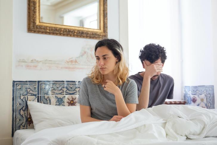 man and woman upset in bed