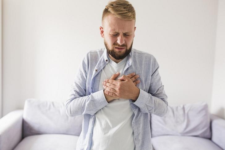 man holding chest