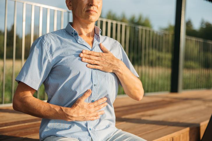 man holding stomach and chest