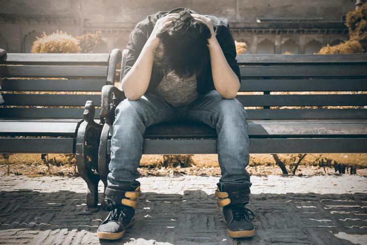 man sitting with his head in his hands