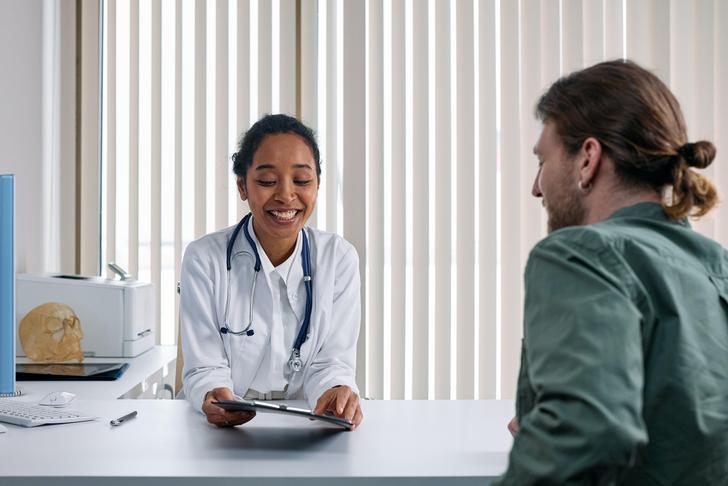 man talking with doctor at a desk