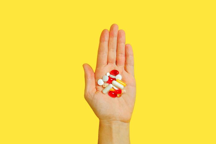 person holding pills in hand