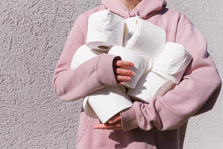 person holding several rolls of toilet paper