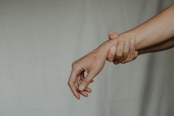person holding their arm