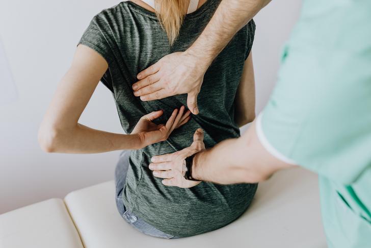 person touching woman's back