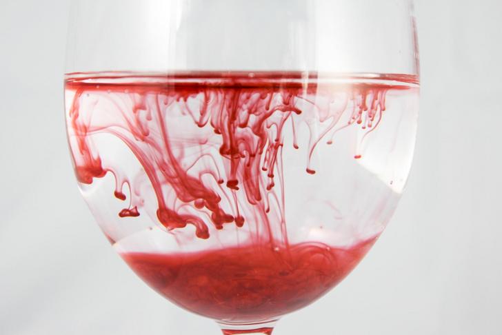 wine glass with water and red food coloring