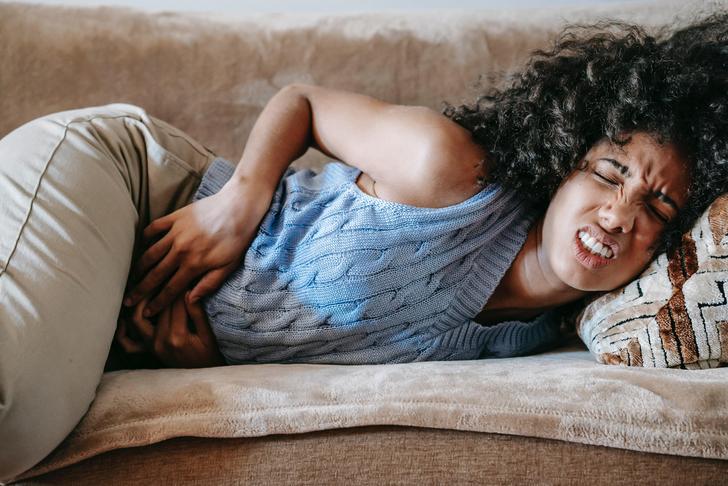 woman holding her stomach in pain