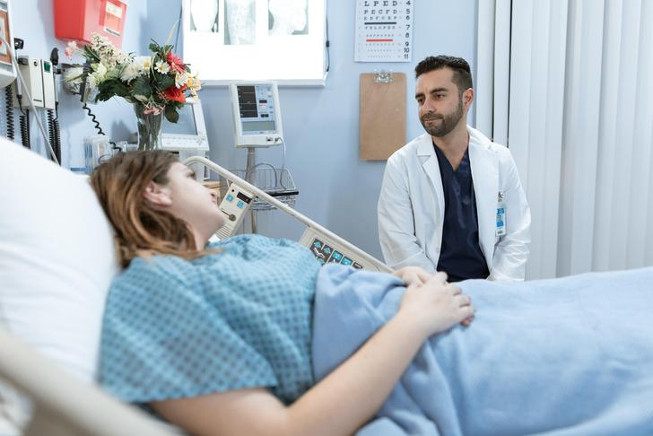 woman in hospital bed talking to a doctor