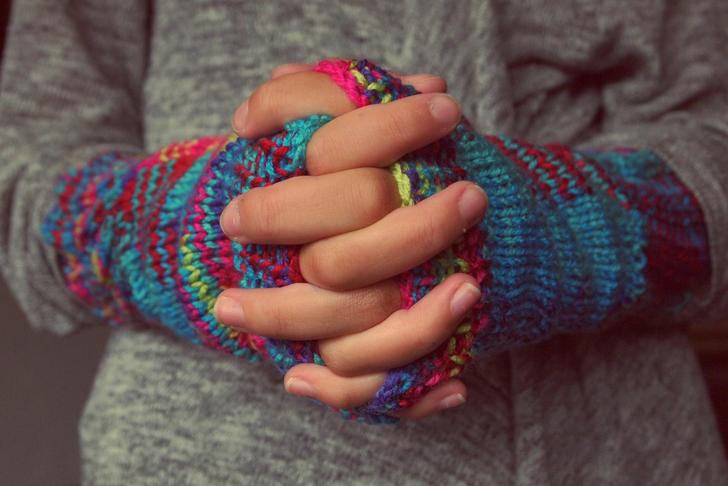 woman in winter gloves folding hands