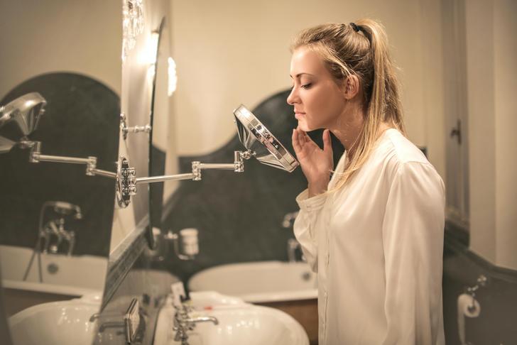 woman looking at herself in the mirror