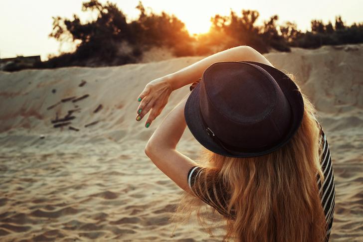 woman shielding face from sun