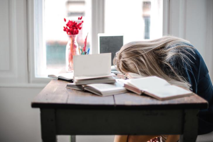 woman with head down on desk