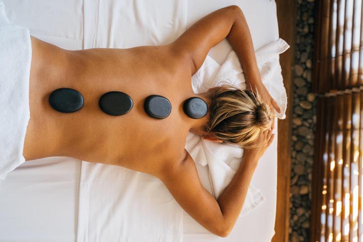 woman with hot stones on back